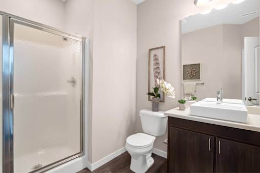 A bathroom with a toilet, sink, and shower at Aventura at Wentzville I & II Apartments, Wentzville, Missouri