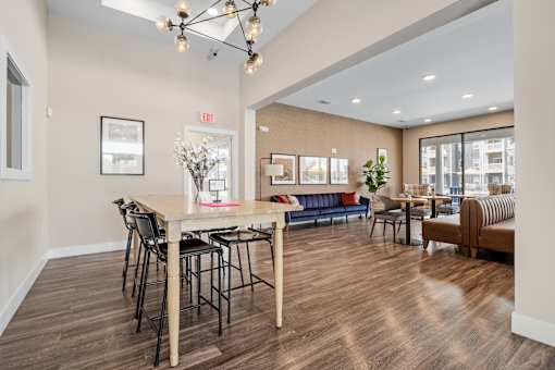 A dining area with a wooden table and chairs at Aventura at Wentzville I & II Apartments, Missouri