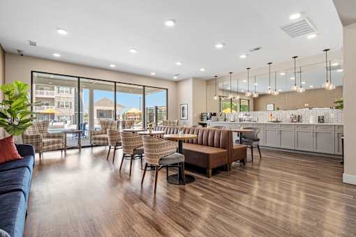 A modern living room with a kitchen area in the background at Aventura at Wentzville I & II Apartments, Wentzville, Missouri
