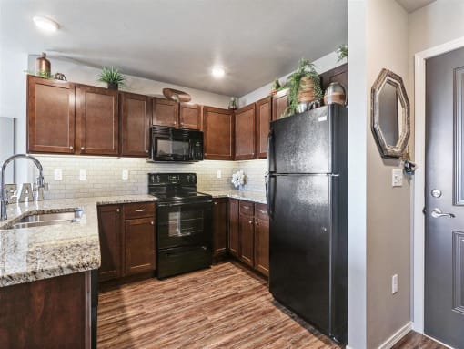 Kitchen with Granite Countertops and Black Appliances
