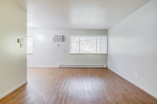 a living with hardwood floors and white walls