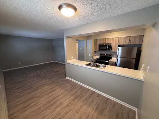 A kitchen area with a stove, oven, and refrigerator.