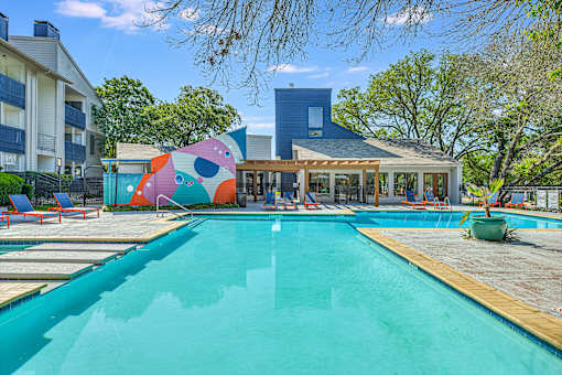 a swimming pool with a building in the background at Peaks at Northwest Hills Apartments, Texas, 78731