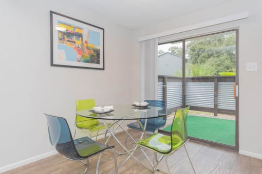a dining room with a glass table and chairs and a large window at The Escapade, San Antonio, 78216