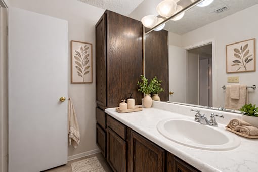 A bathroom with a white sink and a white door.