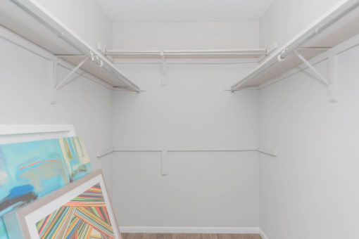 a white room with paintings and white hangers on the wall at The Escapade, San Antonio, 78216
