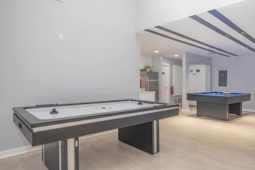 a game room with two pool tables and a foosball at The Escapade, San Antonio, 78216
