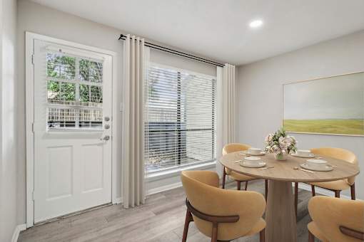 a dining room with a table and chairs at The Escapade, San Antonio, 78216