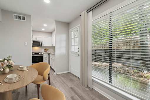 a breakfast nook with a large window and a table and chairs at The Escapade, San Antonio, Texas