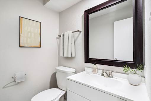 a bathroom with a mirror and a toilet and a sink at The Escapade, San Antonio, Texas