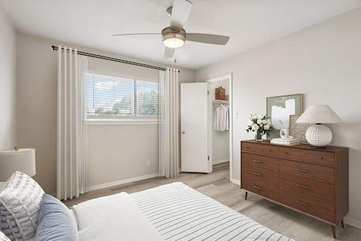 a bedroom with a ceiling fan and a dresser at The Escapade, San Antonio, 78216