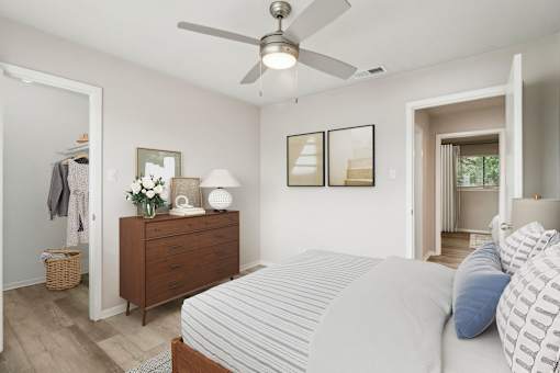 a bedroom with a large bed and a ceiling fan at The Escapade, San Antonio, Texas