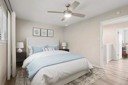 a bedroom with a bed and a ceiling fan at The Escapade, San Antonio, 78216