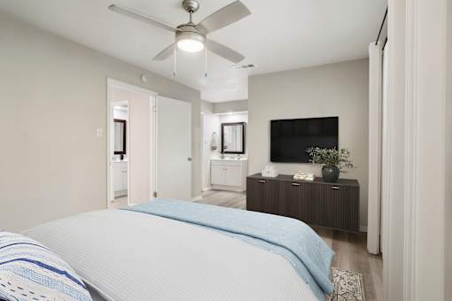 a bedroom with a large bed and a ceiling fan at The Escapade, San Antonio, Texas