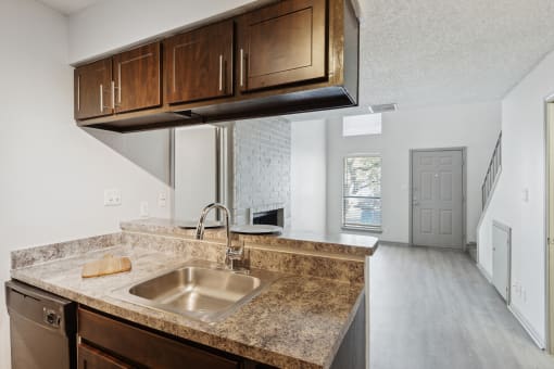 an empty kitchen with a sink and a counter top