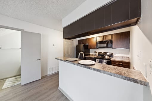 a kitchen with a counter top and a refrigerator