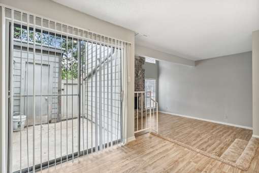 a living room with a sliding glass door to a balcony at The Escapade, San Antonio, Texas