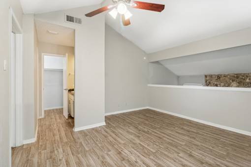 the bedroom of an apartment with a ceiling fan at The Escapade, Texas