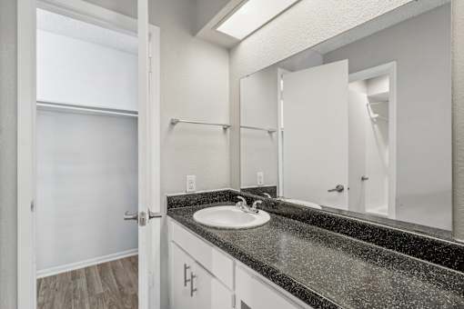 the ensuite bathroom of our A7 apartment at The Escapade with sink and mirror at The Escapade, San Antonio, 78216