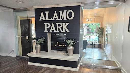 A sign that says Alamo Park is on a black background.