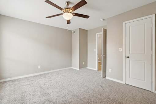 A room with a ceiling fan and carpeted floor at Knoll Crest, San Antonio, Texas 78240