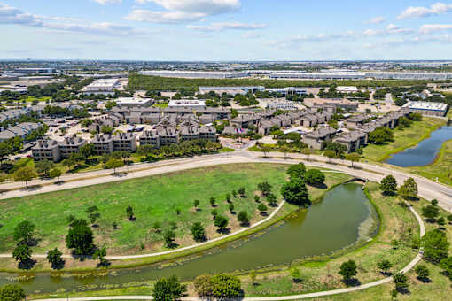 A bird's eye view of a residential area with a river running through it.