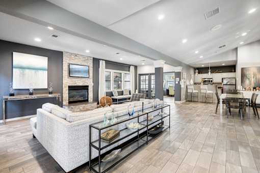 A modern living room with a fireplace and a large couch.