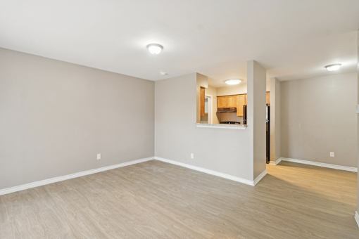 A room with a wooden floor and a small kitchen area at Knoll Crest, San Antonio, Texas 78240