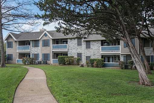 exterior view of an apartment building with a sidewalk