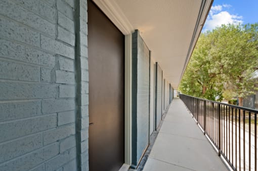 a long balcony with a metal fence on the side of a building at Sunset Heights, San Antonio
