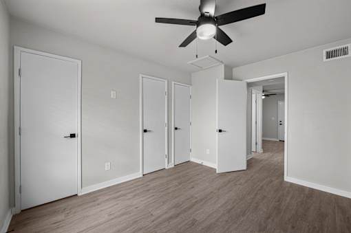 an empty living room with white walls and a ceiling fan at Sunset Heights, Texas