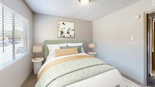 A bedroom with a large bed and a painting on the wall.