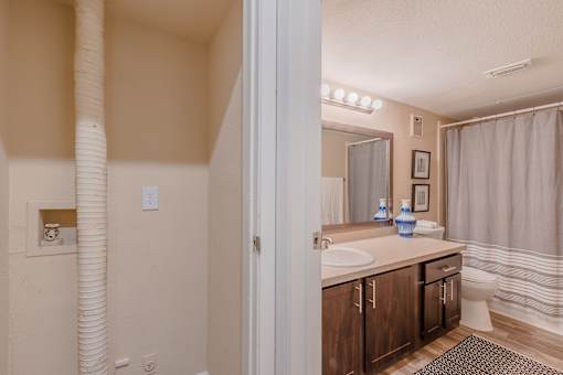A bathroom with a white sink and a white toilet.