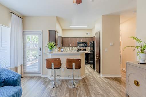 A kitchen with a bar stool and a counter.