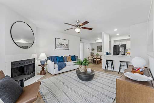 Open concept living room with fireplace and kitchen at Knoll Crest Apartments, San Antonio, TX 78240