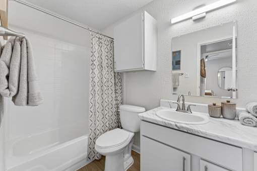 Bathroom with white vanity and marble countertop at Knoll Crest Apartments, San Antonio