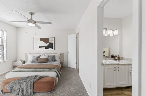 a bedroom with a bed and a ceiling fan at The Hudson, North Richland Hills