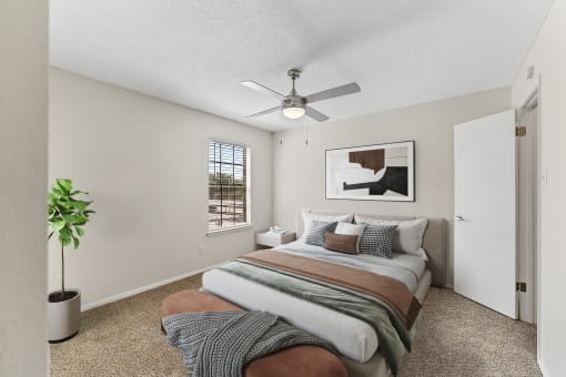 a bedroom with a bed and a ceiling fan at The Hudson, North Richland Hills, Texas