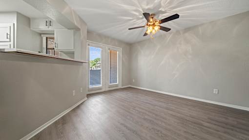 an empty living room with a ceiling fan at Polo Clubs Apartments, Austin, TX 78729