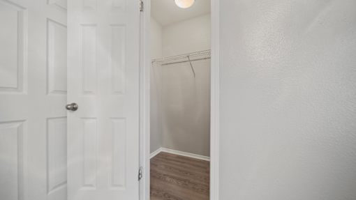the closet in a small bedroom with a white door at Polo Clubs Apartments, Texas