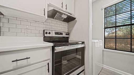 kitchen with a stove and a window at Polo Clubs Apartments, Texas, 78729