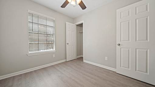 bedroom with a door and a window at Polo Clubs Apartments, Austin, Texas