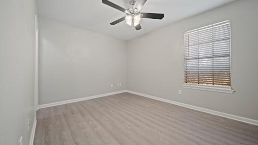 Bedroom with window at Polo Clubs Apartments, Austin, TX 78729