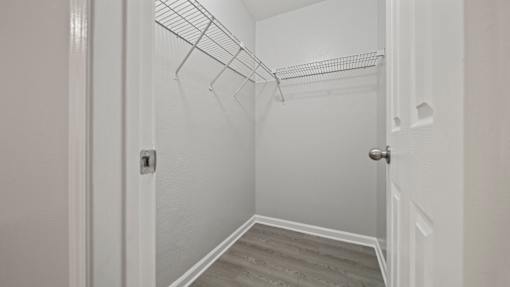closet in a bedroom with white walls and wood flooring at Polo Clubs Apartments, Austin, 78729