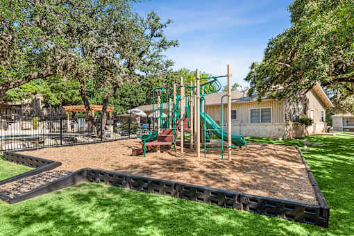 playground with a green slide at Crosspoint Oaks at Boerne, Boerne