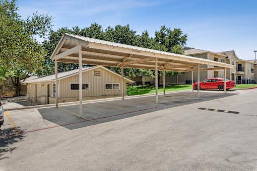parking lot with a covered parking  at Crosspoint Oaks at Boerne, Boerne, TX