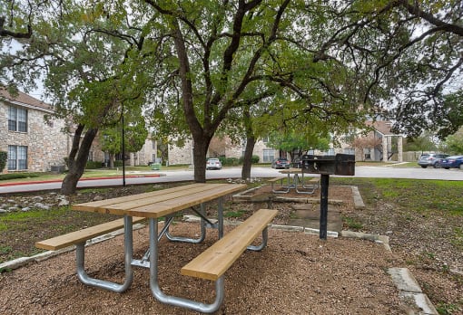 a picnic area with benches and a grill at The Broadwater at Salado Creek, Texas