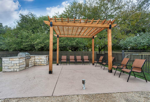 a patio with a wooden pavilion and benches at The Broadwater at Salado Creek, San Antonio, TX, 78216