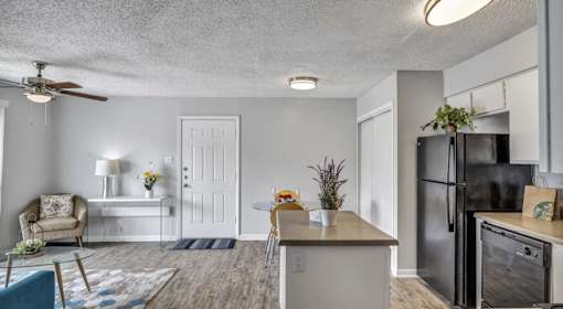 A kitchen with a refrigerator, dishwasher, and oven.
