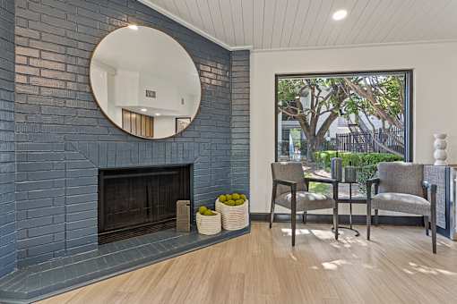 A living room with a fireplace and a mirror above it. at Tradewinds, Windcrest, TX